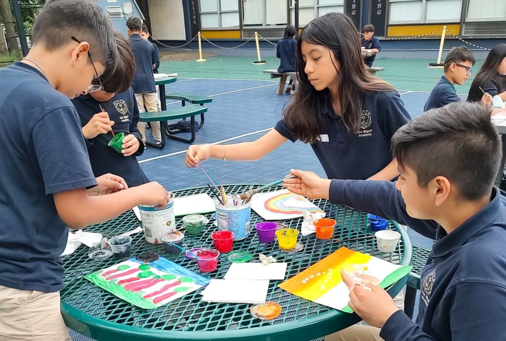 painting outside with classmates. Creating expressions of harmony.